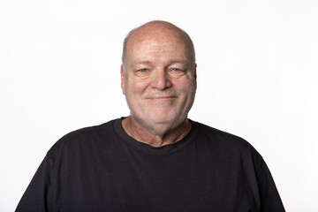 Fototapeta premium Portrait of Smiling 60 Year Old Man in Dark Shirt Isolated on White Background