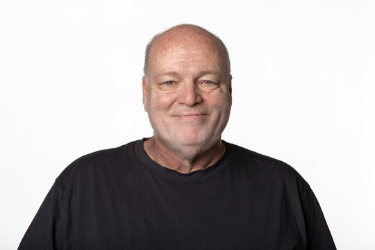 Portrait of Smiling 60 Year Old Man in Dark Shirt Isolated on White Background