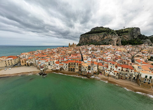Aerial view of Cefalu town with a gathering storm in the background. Cefal&ugrave; is a coastal town in northern Sicily, Italy. Its Duomo, Cefal&ugrave; Cathedral, is a world heritage site