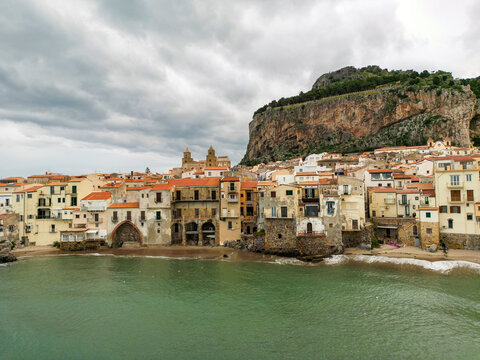 Aerial view of Cefalu town with a gathering storm in the background. Cefal&ugrave; is a coastal town in northern Sicily, Italy. Its Duomo, Cefal&ugrave; Cathedral, is a world heritage site