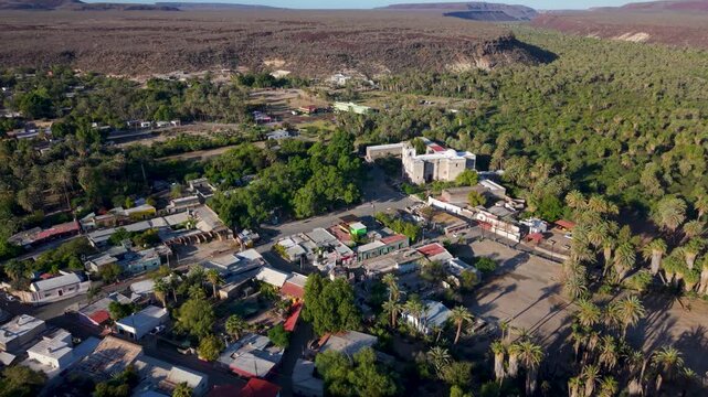 Watch aerial views showcasing Mission Church and the surrounding oasis town of San Ignacio in Baja California Mexico from above.