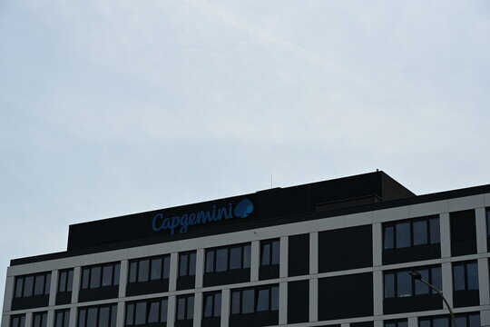 Capgemini Logo on Top of Modern Office Building in Wroclaw Poland Against Blue Sky