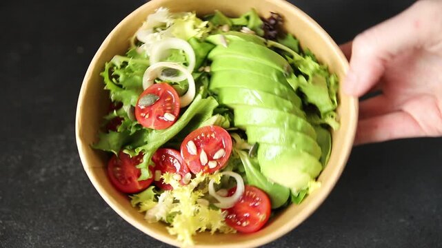 Avocado bowl vegetable salad lunch or dinner tasty snack organic fresh and gourmet food background on the table, rustic food, top view, copy space keto and paleo diets vegetarian and vegan food