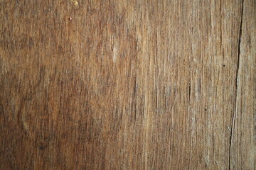 Obraz premium Close-up of a dark brown weathered natural wood grain texture surface background for rustic design layouts.