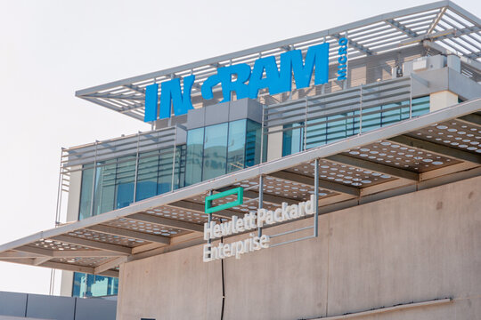 14 January 2026, Dubai, UAE: Hewlett Packard Enterprise and Ingram Micro company logos displayed on a modern corporate office building, symbolizing technology and business