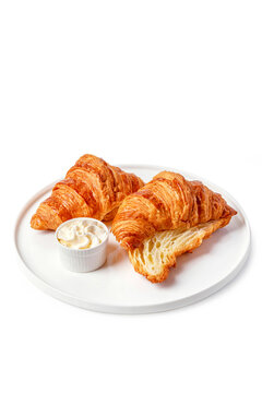 Croissants with butter on a white background