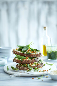 Wild Garlic Pesto Toast with Cream Cheese and Pine Nuts &ndash; Spring Herb Food Photography