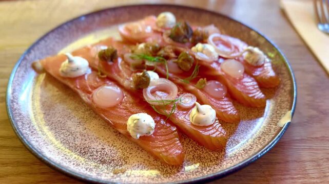 plate of salmon gravlax appetiser with toppings of cream cheese and sugar