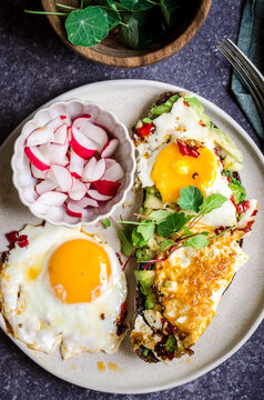 Toast with avocado and spicy fried eggs