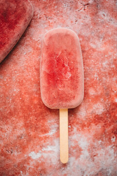 Raspberry popsicle on a red background