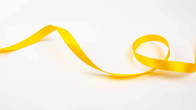 Abstract shape color yellow ribbon isolated on white background.     top view