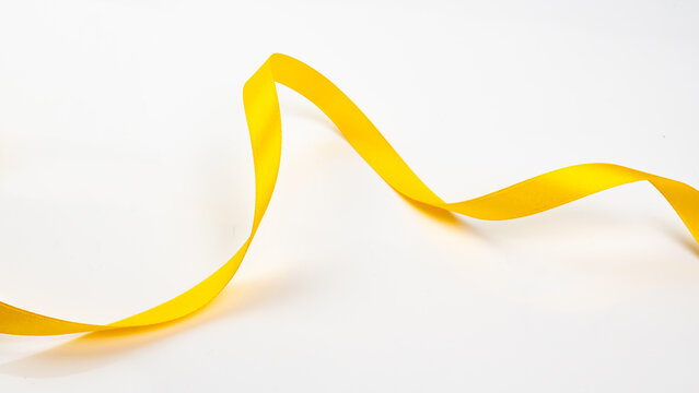 Abstract shape color yellow ribbon isolated on white background.     top view