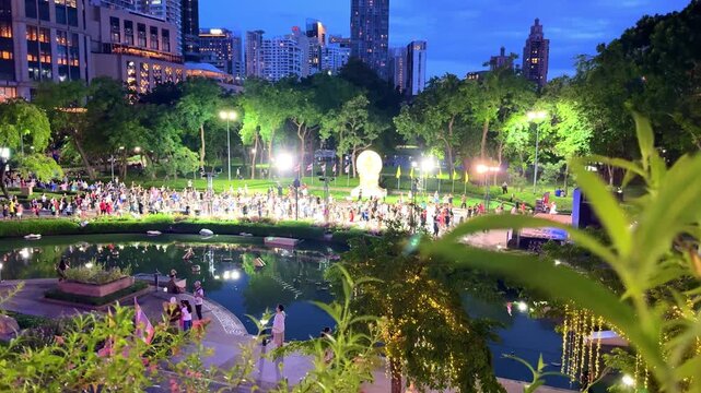 28 May 2026 Hundreds of People exercising in Benchasiri Park in Phrom Phong BKK Bangkok on a warm sunset night