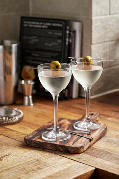 Dry Martini with Olives on Wooden surface, kitchen