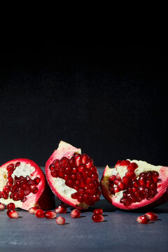 Pomegranate Sliced Open on a Dark Background