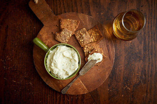 Rustic Crackers and Whiskey Cheese Dip on a Wooden Table