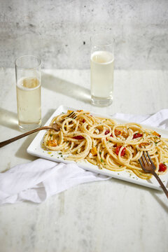 Bucatini Basta with Fresh Cherry Tomatoes and Squash and Glasses of Champagne