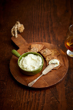 Rustic Crackers and Whiskey Cheese Dip on a Wooden Table