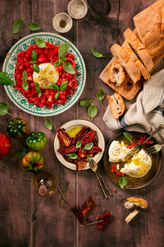 Caprese salad with loaf of bread and sun dried tomatoes