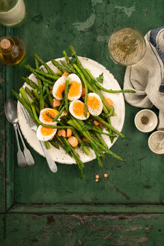 Plate of fresh asparagus with soft boiled eggs
