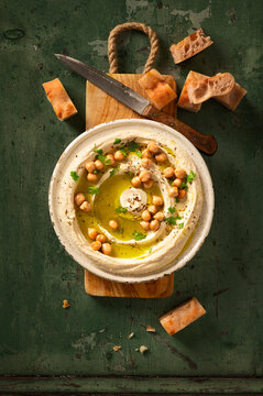 Hummus dip in ceramic plate with pita bread