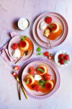 Cr&egrave;me caramel classic French custard dessert topped with a layer of soft caramel sauce and served with strawberries, apple mint and whipped cream.