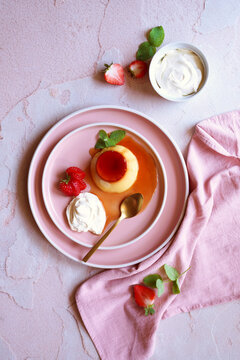 Cr&egrave;me caramel classic French custard dessert topped with a layer of soft caramel sauce and served with strawberries, apple mint and whipped cream.