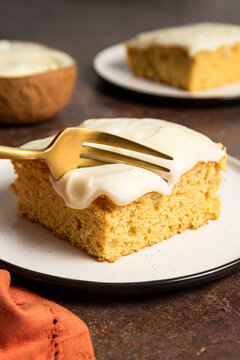 Fork cutting into slice of sheet cake