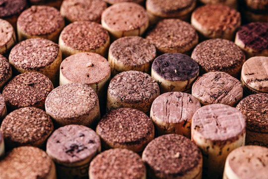 Close-up pattern of textured red wine corks arranged in a tight grid.