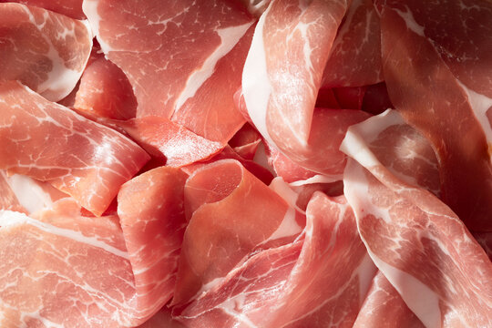Macro shot of thinly sliced prosciutto meat