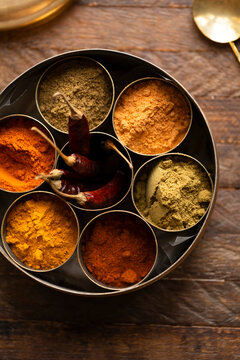 Traditional Indian anjarai petti spice box with assorted ground spices
