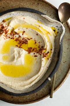 Homemade hummus with olive oil and Aleppo pepper