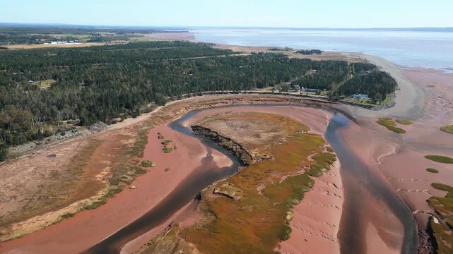Drone view of Portapique coastline Nova Scotia Canada with forest and scattered homes. Bay of Fundy extreme tides shape shoreline creating scenic natural landscape and travel destination