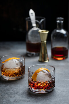 Bourbon Chambord cocktail with spherical ice and orange twist