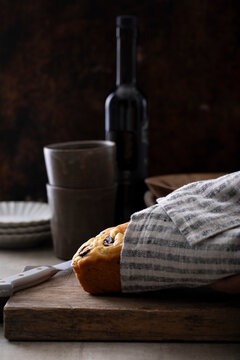 Olive oil loaf cake with olives on rustic board