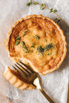 Macro shot of mini quiche topped with fresh thyme