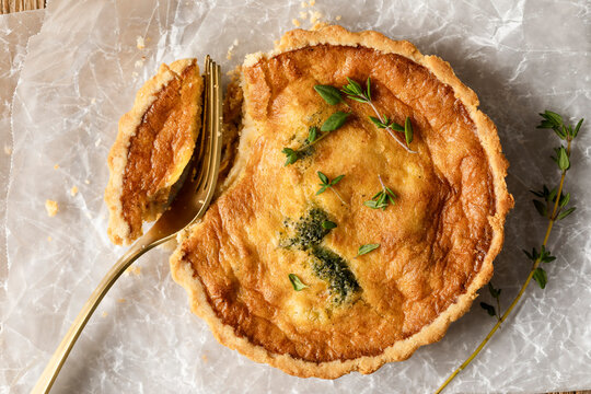 Macro shot of mini quiche topped with fresh thyme