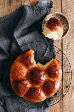 Fresh Japanese milk bread buns on rack with rustic cloth