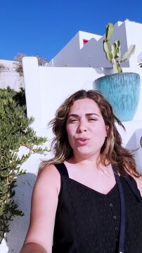 Woman smiling while exploring santorini on summer vacation