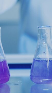 Chemical, beaker and liquid with swirl in lab for forensic pathologist, research or sample analysis. Toxicology exam, medical study and chemistry with scientist and experiment for drug screening