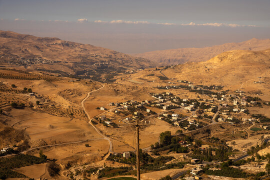 Scenic valley view of a rural desert village and mountain roads in Al-Karak region, Jordan