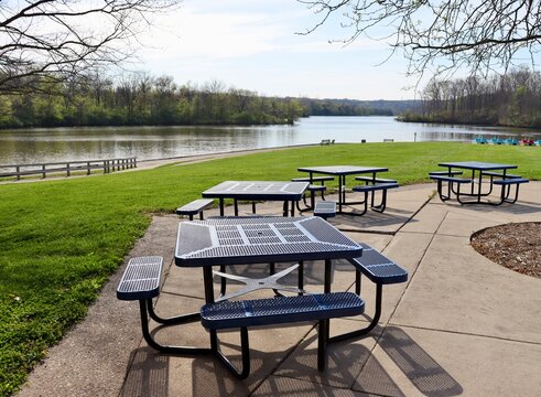 The blue metal picnic tables in the park.