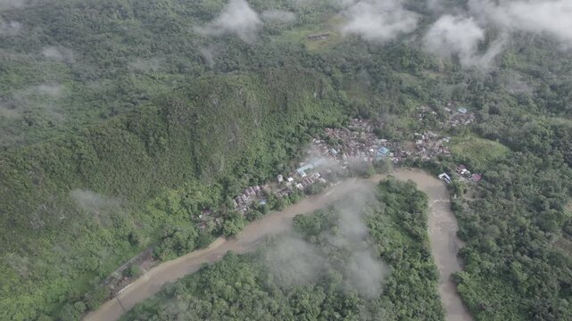 Exploring a Rural River Bend Surrounded by Lush Forest and Mist