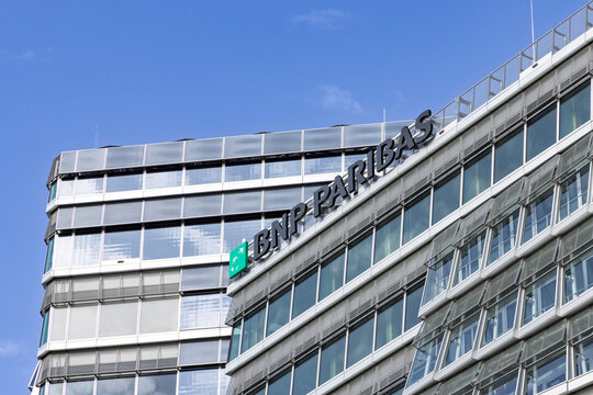 Amsterdam, Netherlands - May 23, 2026: Close view of the BNP Paribas corporate bank sign on a contemporary glass and steel office building in the Zuidas business district of Amsterdam.