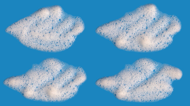 White soap foam bubbles isolated on blue background. Abstract detergent suds texture for cleaning, hygiene, laundry, dishwashing, skincare, sanitation and fresh minimal design concept.