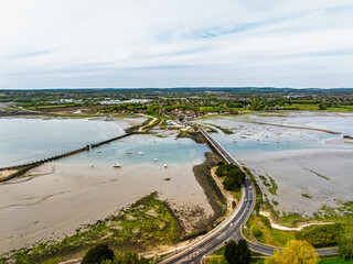 Naklejka premium Bridge and Quay to the Hayling Island from a dron at low tide, Havant, Hampshire, England
