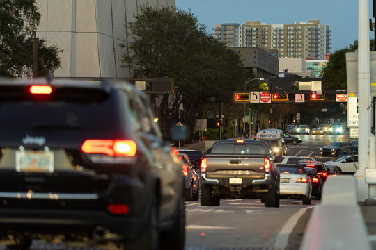 Cars driving at traffic lights on American wide road intersection in city area. Transportation system in USA. Sarasota, USA - May 7, 2023.