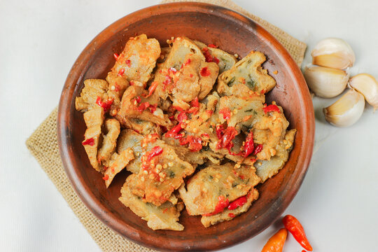 Tahu kocek, or geprek aci tofu, is a popular snack originating from Jember, East Java, Indonesia. It's made from fried tofu pieces filled with tapioca flour batter and served with onion chili sauce.