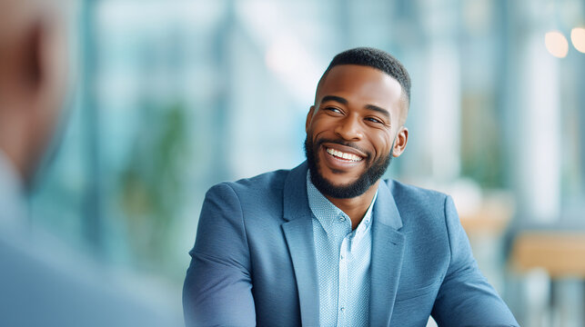 Professional HR onboarding discussion with confident businessman smiling naturally, head and torso only, shallow depth of field, modern office background