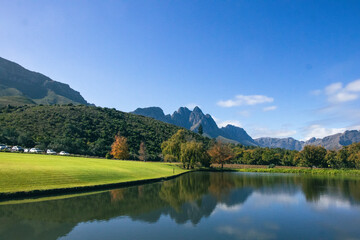 Fototapeta premium Mountain lake and green lawns at a Cape Winelands estate